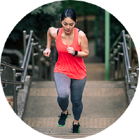 A woman exercising by running up the stairs.